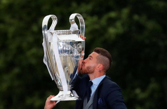 Soccer Football - Real Madrid celebrate winning the Champions League Final - Madrid, Spain - May 27, 2018   Real Madrid's Sergio Ramos celebrates with the trophy during victory celebrations   REUTERS/Paul Hanna